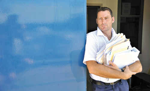 COUNTING THE COST: Storm Financial victim Sean McArdle with some of the huge pile of paperwork that he has had to prepare in the court case against the company. COUNTING THE COST: Storm Financial victim Sean McArdle with some of the huge pile of paperwork that he has had to prepare in the court case against the company.